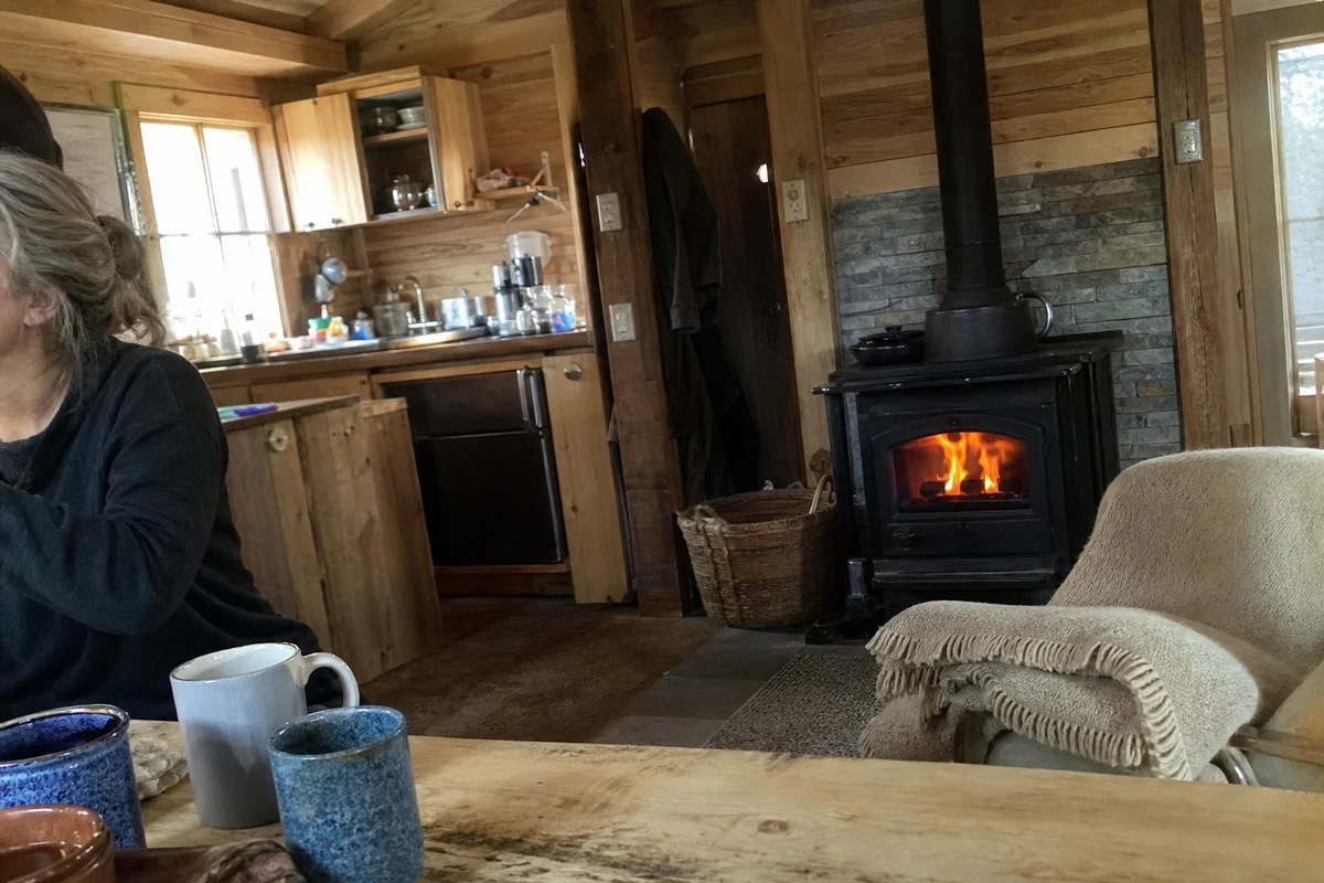 The Stables interior with wood fire and kitchenette, warm and lived-in